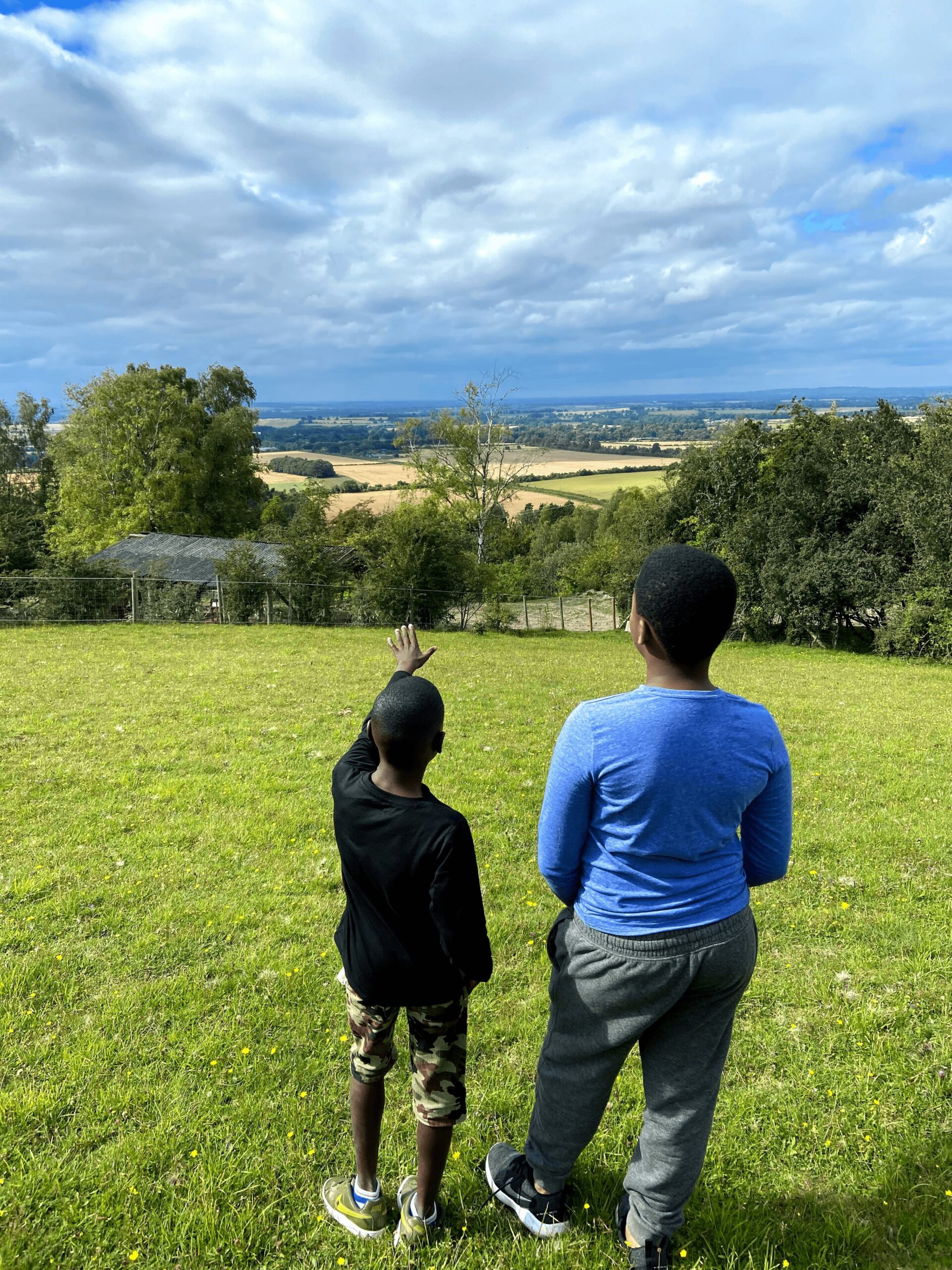 young boys looking out over a countryside vista