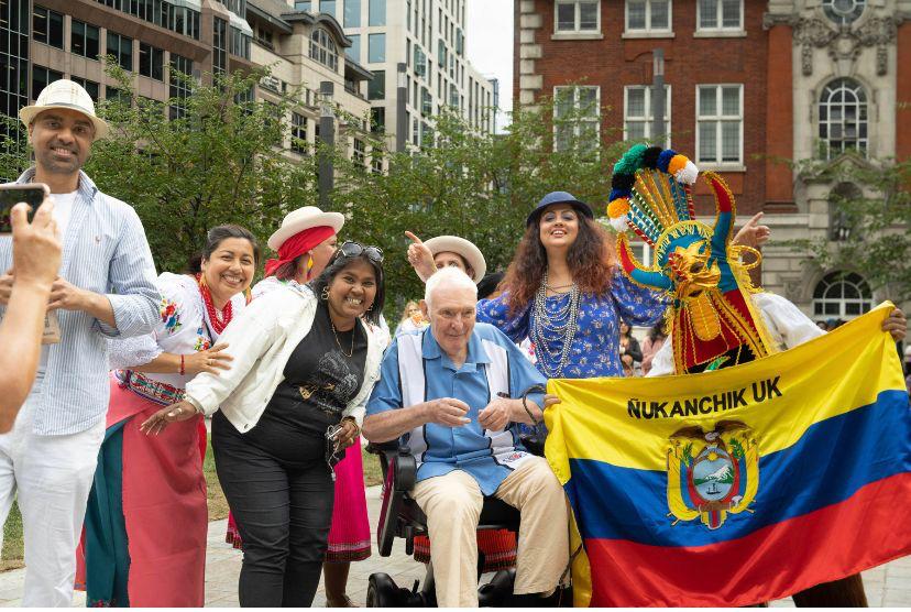 person in fancy dress holding the Venezuelan flag